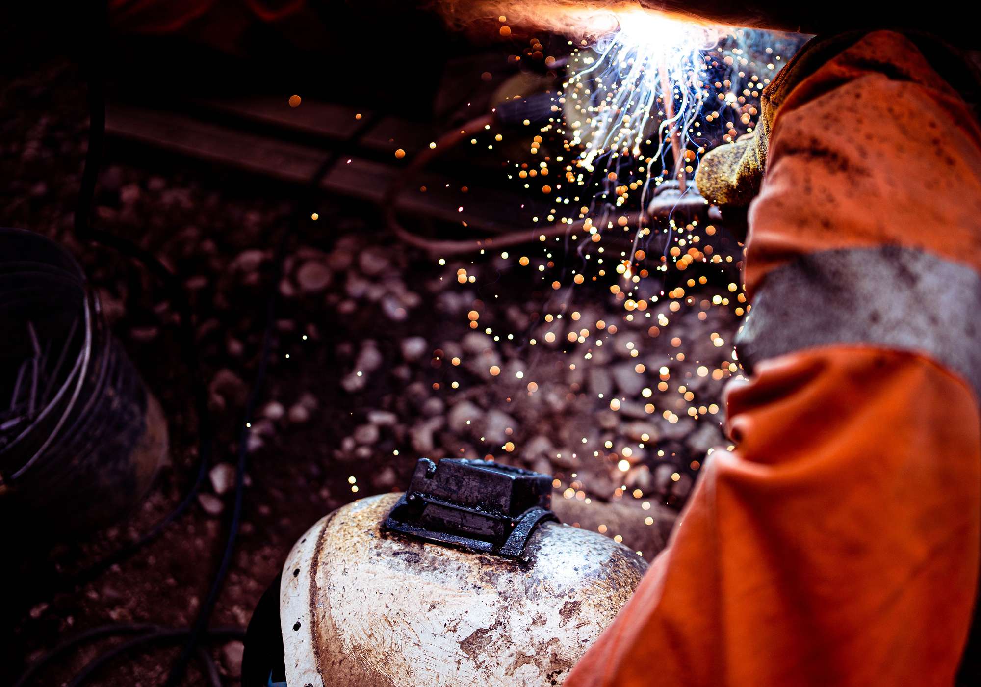 closeup-of-a-worker-welding-the-railroad-FQTP2RG